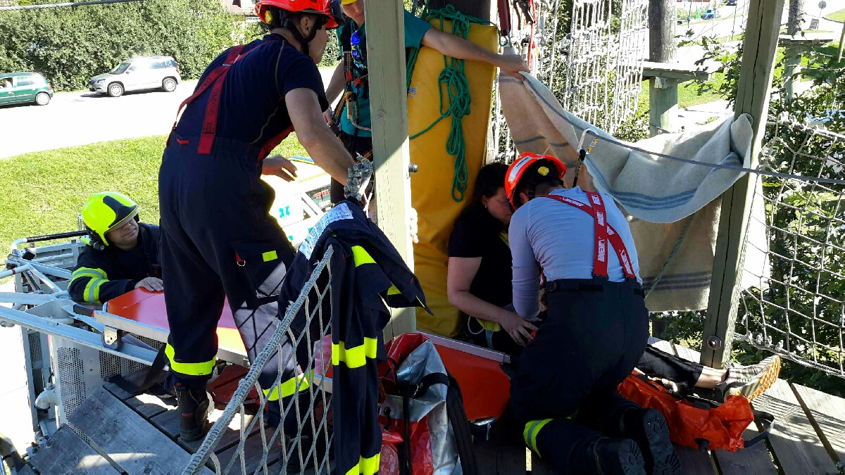 Hasiči ošetřují zraněnou ženu na atrakci v lanovém parku.jpg