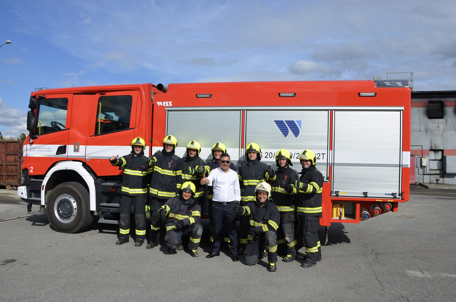 The delegation DNBC has visited the Fire protection and training centre in Brno_a joint photo in front of fire truck.jpg